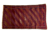 4x7 vintage Belouch rug, diagonal madder red, indigo, camel, gray lattice patterns, with visible foundation wear.