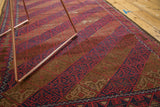 Hand knotted Belouch rug, dynamic diagonal bands, geometric lattice in red, indigo, camel.