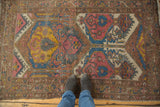Asymmetric multi-panel palmette design on vintage Persian Lilihan rug in blush, blue, saffron.