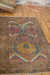 Corner of vintage Lilihan rug with intricate floral border and cloudband design.