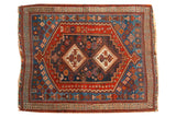 Antique Afshar rug with geometric double medallions on dark indigo, featuring rich tribal red patterns.