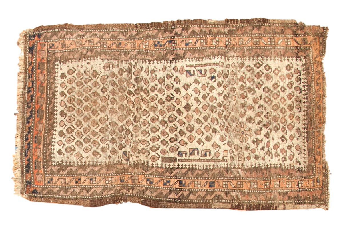 Antique Belouch rug: rare ivory field, allover pale terra cotta and charcoal boteh, worn pile.