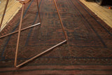 Vintage Belouch rug with dark red and navy geometric tribal patterns, showing mostly even wear.
