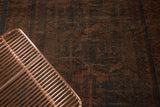 Dark palette of a vintage hand knotted Belouch rug with madder red and navy geometric patterns.