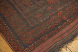 Vintage Belouch rug corner, with geometric tribal border and striped kilim in madder red, navy, brown.