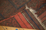 Vintage Belouch rug's hand-knotted pile with madder red and striped kilim back.