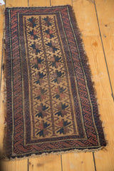 Antique Belouch runner: double starbursts in navy, chestnut, aubergine on camel, geometric channels, worn edge.