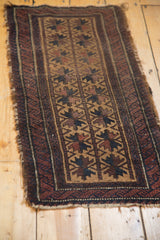 Antique hand knotted Belouch runner corner with tattered fringe and geometric starburst patterns.