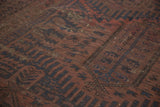 Faded madder root red and navy geometric motifs on the vintage Belouch carpet.