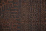Geometric formations with tree-of-life motifs in faded madder red and navy on this vintage Belouch rug.