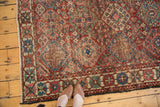 Vintage Baktiari rug, distressed field with geometric diamonds in cherry red and sky blue.