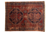Vintage Caucasian rug, navy blue double medallions, geometric red and sky blue patterns.