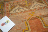 Antique Oushak prayer rug with terra cotta, saffron, and gray geometric patterns and even wear.