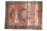 Antique Farahan carpet: ornate medallion, blush rose field, deep navy, and aged patina.