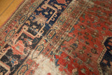Worn antique Farahan carpet pile, exposing pale foundation amidst dark navy and wine red motifs.