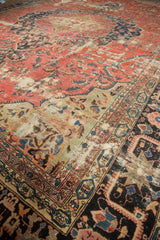 Antique Farahan rug showing blush rose field, oxidized green and navy patterns, storied wear.