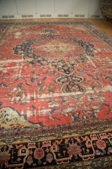 Antique Farahan carpet showing blush rose field, visible foundation, and rich navy-charcoal motifs.