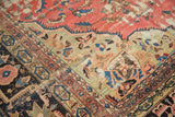 Antique Farahan Sarouk rug corner with ornate borders, blush field, and natural patina.