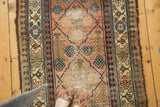 Antique Hamadan runner with unique checkered lily design, pale cinnabar field, and visible foundation wear.