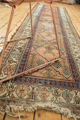 Antique Hamadan rug's lattice panel lily design on a cinnabar field, frayed fringe.