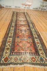 Antique Hamadan rug end, unique checkered lily design, cinnabar red field, ivory border, and storied fringe.