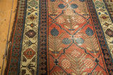 Antique Hamadan runner's cinnabar field, lattice checkered lily design, and colorful geometric border with patina.
