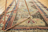 Antique Caucasian rug, geometric diamond and floral motifs in madder red and sea foam green.