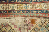 Visible foundation and patch with geometric border patterns on antique Caucasian rug.
