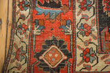 Antique Kurdish Bijar carpet's madder red field with geometric diamond and stylized plant motifs.