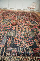 Antique Bijar carpet detail: dark navy field, madder red forest foliage, and pale floral border.