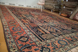 Madder root red border and navy Garden of Paradise field on an antique Kurdish Bijar carpet.