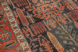 Collector Antique Kurdish Bijar carpet, dark field with pictorial tree motifs and aged texture.