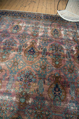 Distressed vintage Yezd carpet in rare purple plum, bronze, and teal vase and bud motifs.