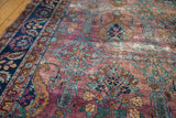Purple plum distressed Yezd carpet with teal, bronze floral motifs and textured pile.