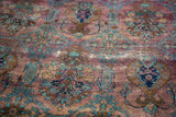 Distressed Yezd carpet with rare purple plum field and teal floral motifs.