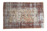 Distressed vintage Mahal rug with primitive floral motifs on beige field, blue and red, 6'5