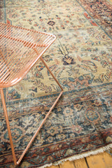 Vintage Mahal rug's worn beige field, blue and red patterns, and tattered fringe.