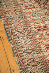 Antique Caucasian carpet: geometric lattice motif and serrated border, showing historic edge wear.