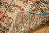 Tightly woven geometric foundation and frayed fringe of an antique Caucasian rug.