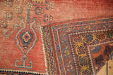 Antique Afshar rug fold revealing colorful border, macramé selvedge, and textural distressed pile.