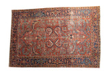 Distressed vintage Heriz carpet, allover serrated leaves, brick red field, navy blue border.