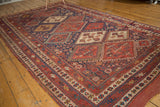 Antique Afshar carpet corner, geometric borders in madder red, indigo, and saffron hues.