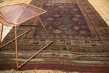 Belouch carpet with intricate madder root red, navy border and worn plain-woven end.
