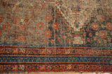 Vintage Persian Afshar rug's worn brick red and navy borders with meandering vine patterns, threadbare.