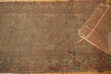 Antique Persian camel hair runner's worn field, foundation showing through faded allover patterns.