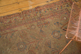 Tattered edge of antique camel hair runner, showing faded allover motifs and pile worn to foundation.