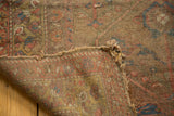 Worn pile of antique camel hair rug, revealing foundation and tattered edge.