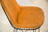 Close-up of stains and signs of use on the original orange wool seat cover.