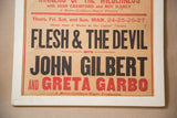 Close-up of vintage movie poster: 'Flesh & The Devil', 'John Gilbert', 'Greta Garbo', showing paper wear.