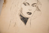 Close-up of a 1930s charcoal portrait showing the aged paper's texture and a frayed edge.